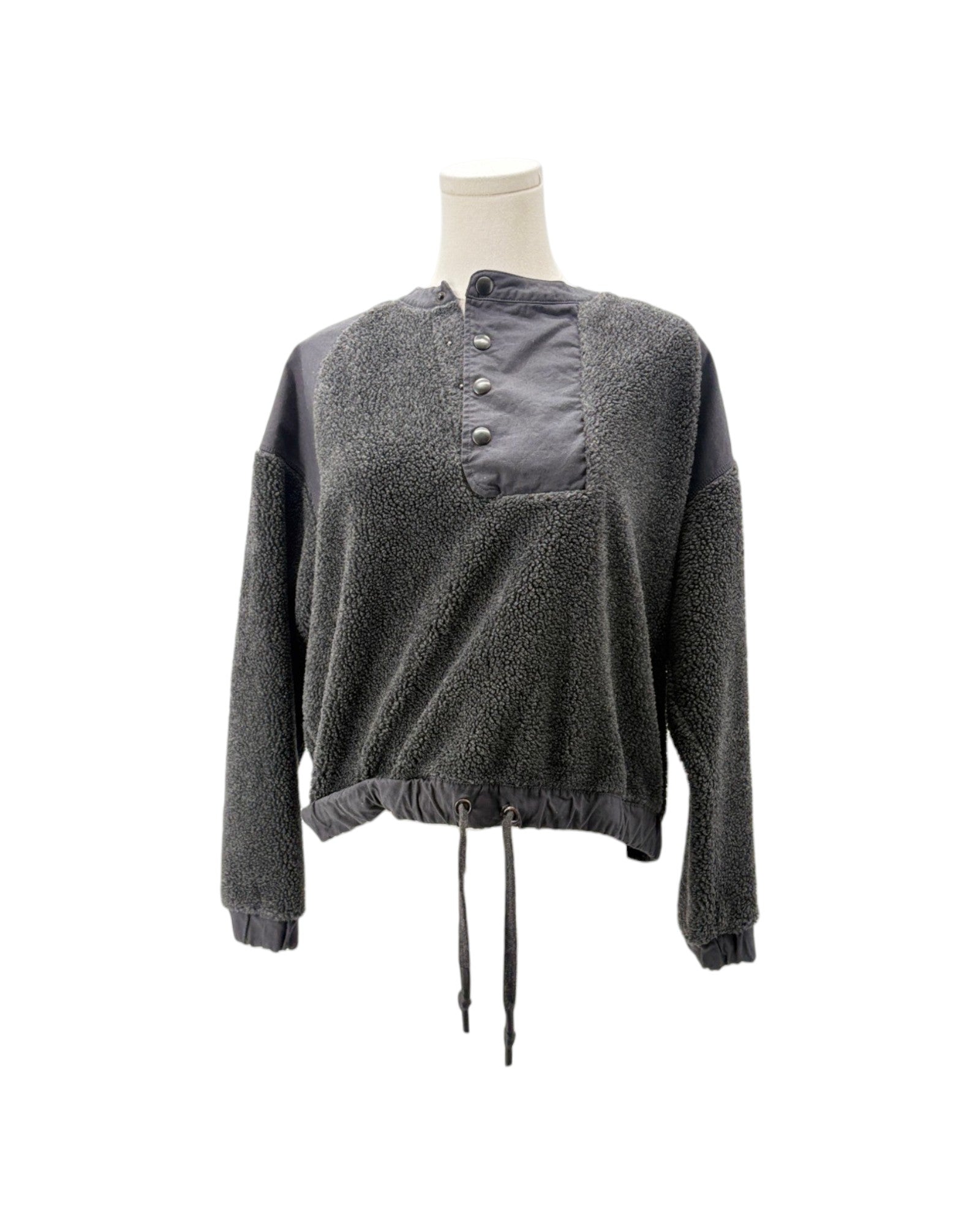 A dark gray textured fleece pullover sweater with a contrasting solid gray button-up collar panel, displayed on a mannequin torso against a white background.