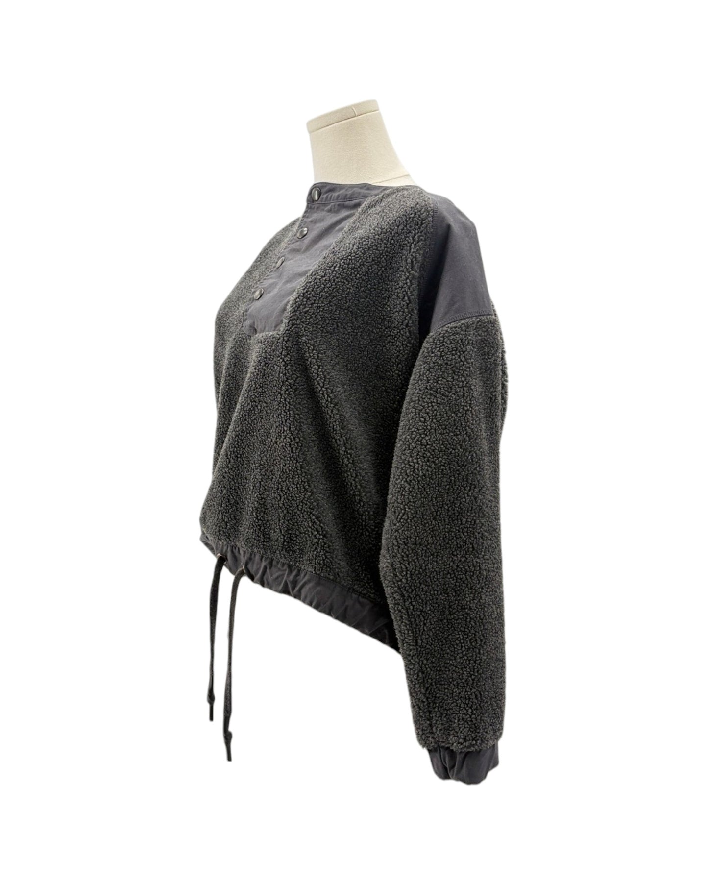 A dark gray cropped fleece pullover sweater with a contrasting solid dark gray collar and button placket, shown on a mannequin torso against a white background.