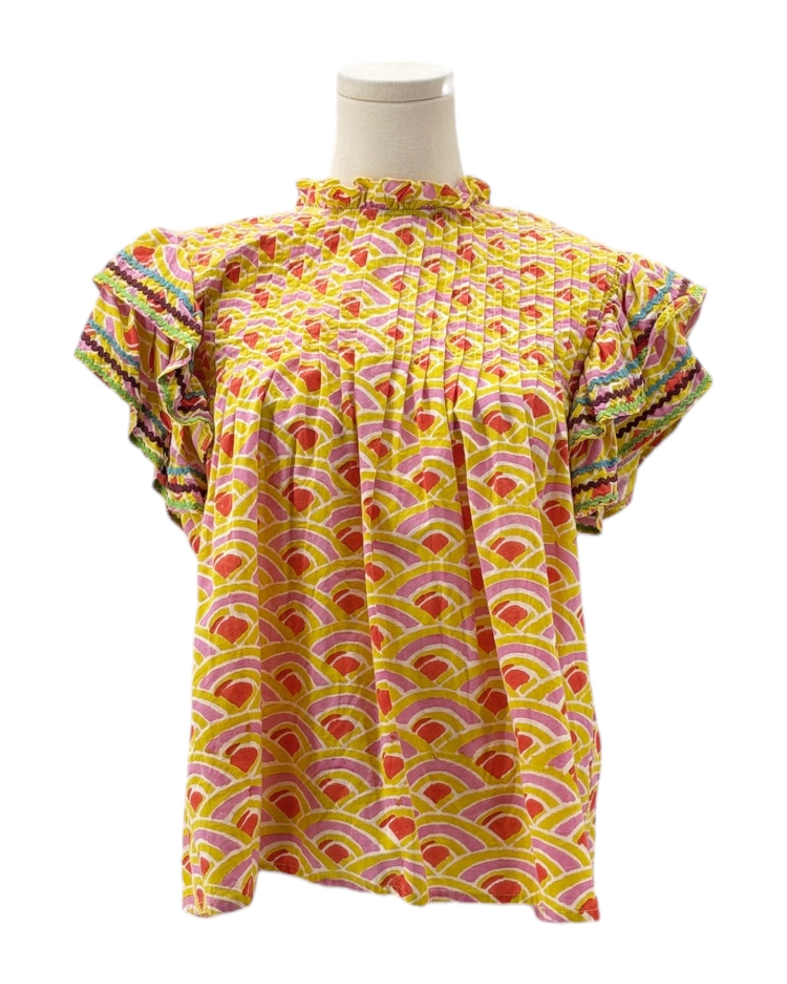 Colorful patterned blouse on a mannequin against a white background