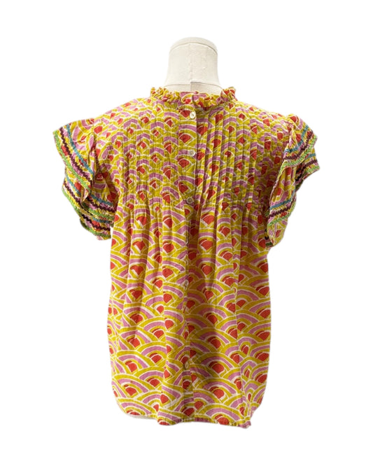 Colorful patterned top on a mannequin against a white background