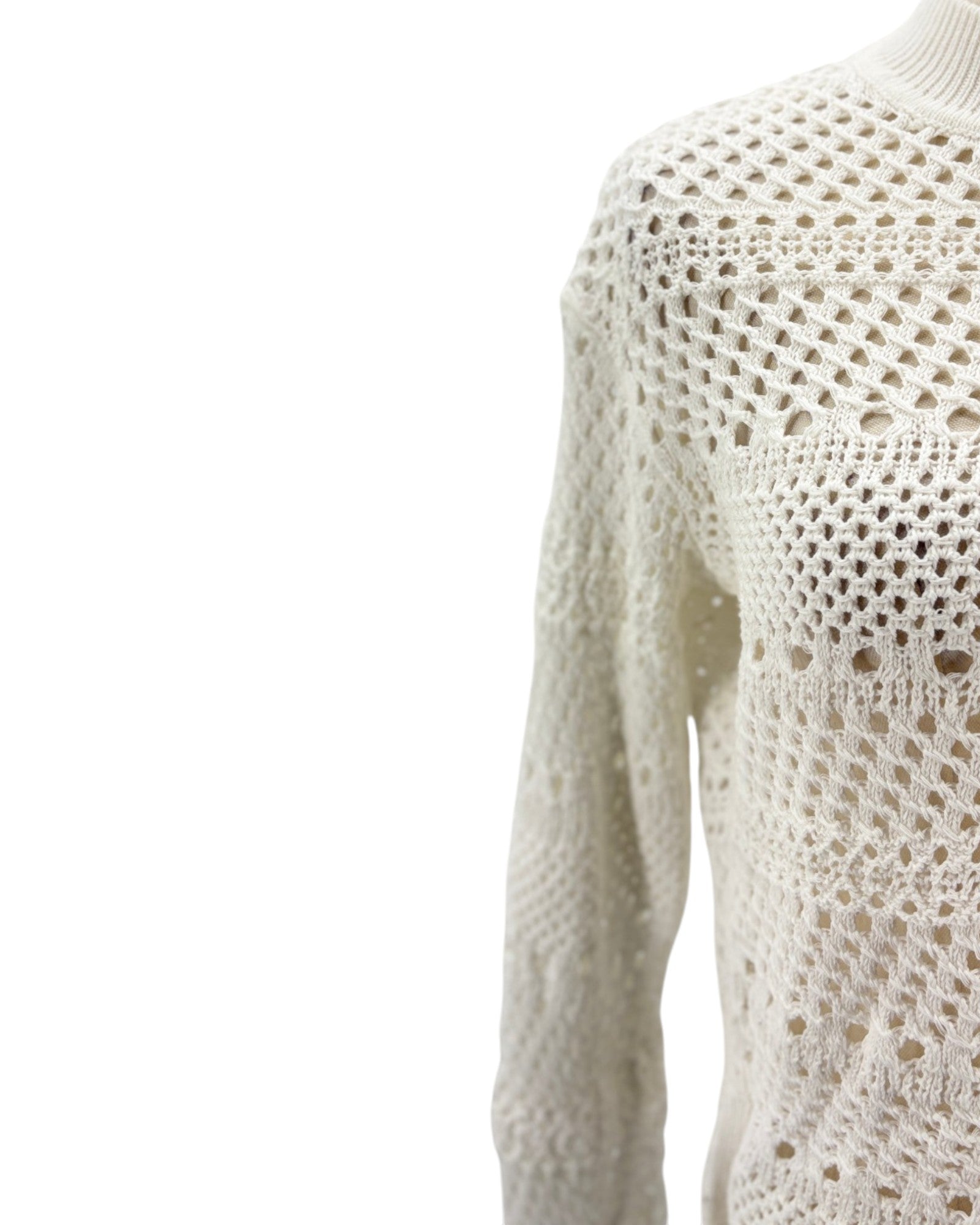 Close-up of a white crochet sweater on a white background