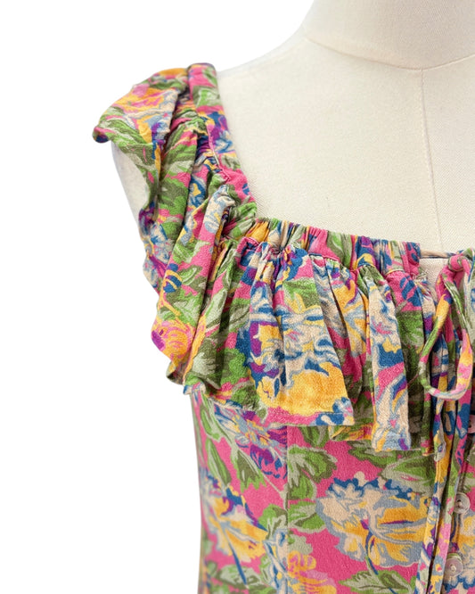 Colorful floral dress on a mannequin against a white background