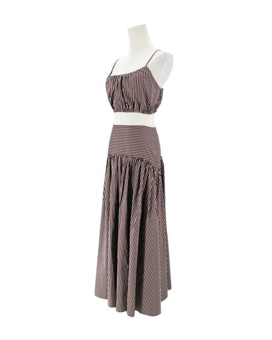A sleeveless two-piece set consisting of a ruched crop top and a tiered maxi skirt, both in a brown and white striped pattern, displayed on a white mannequin against a white background.