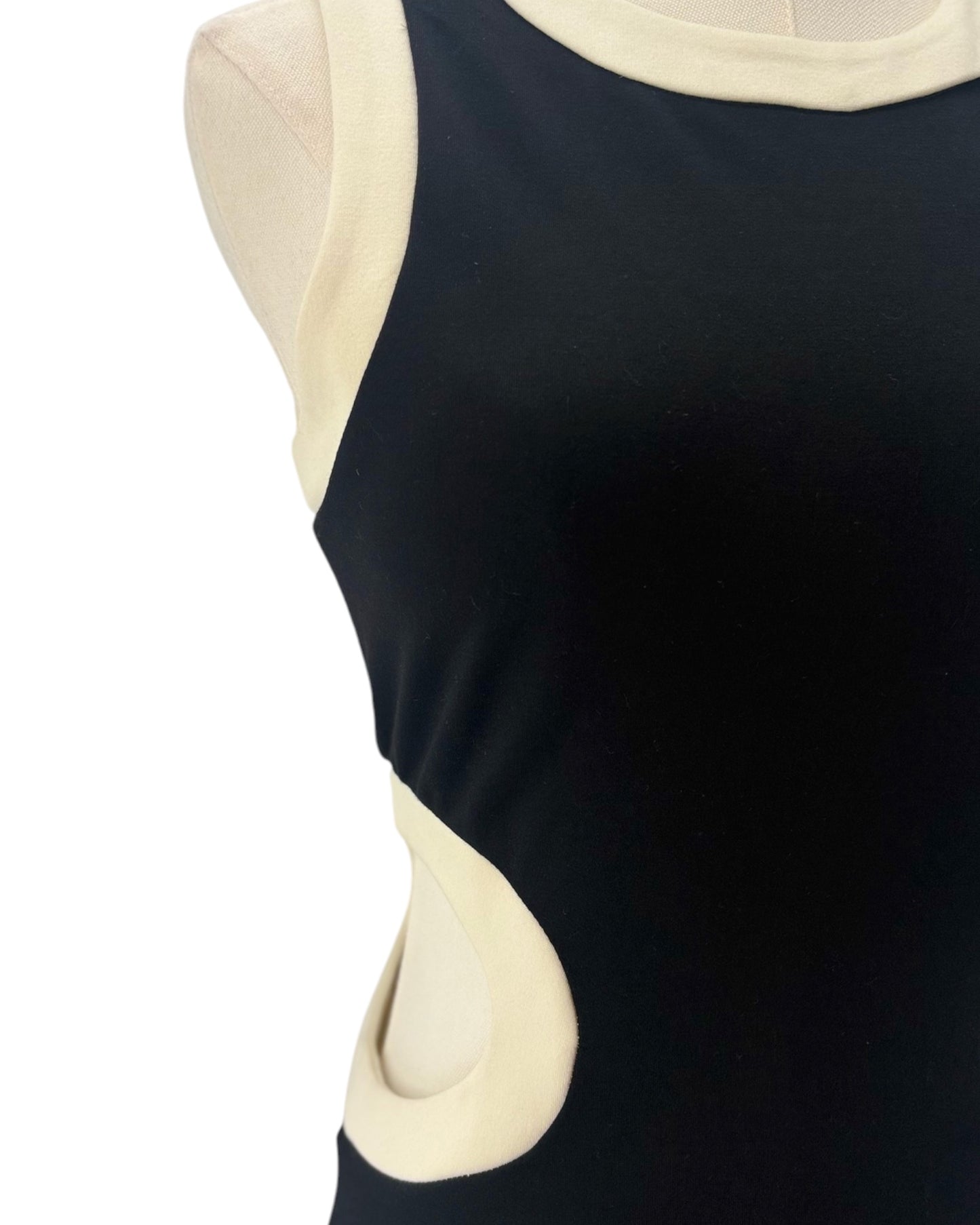 Black dress with beige accents on a mannequin against a white background