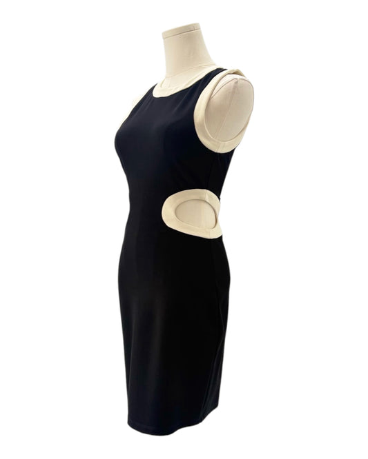 Black dress with beige pads on a mannequin against a white background