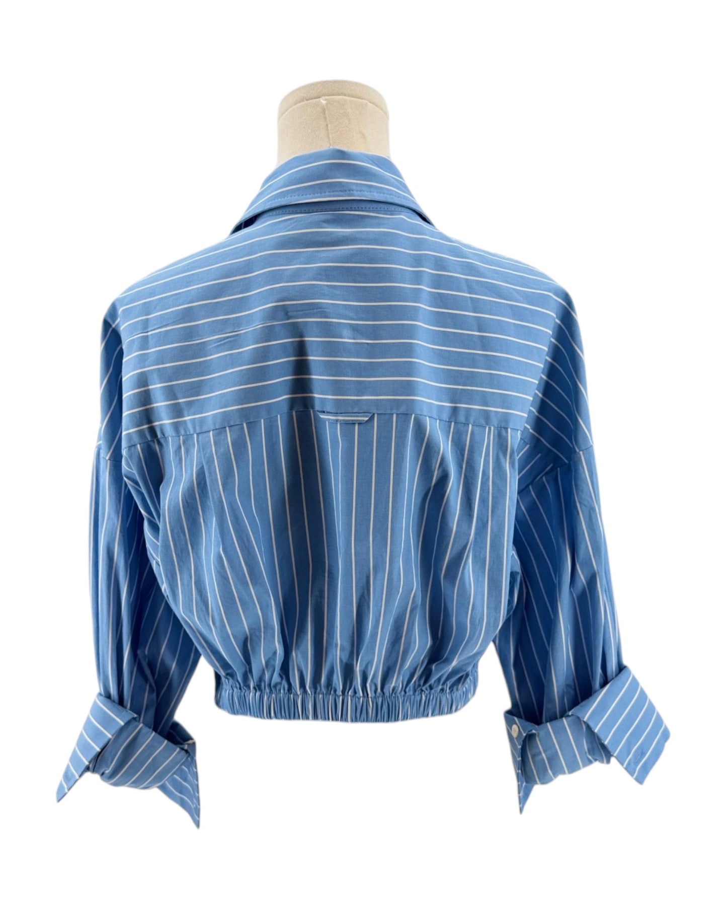 Blue striped shirt on a mannequin against a white background