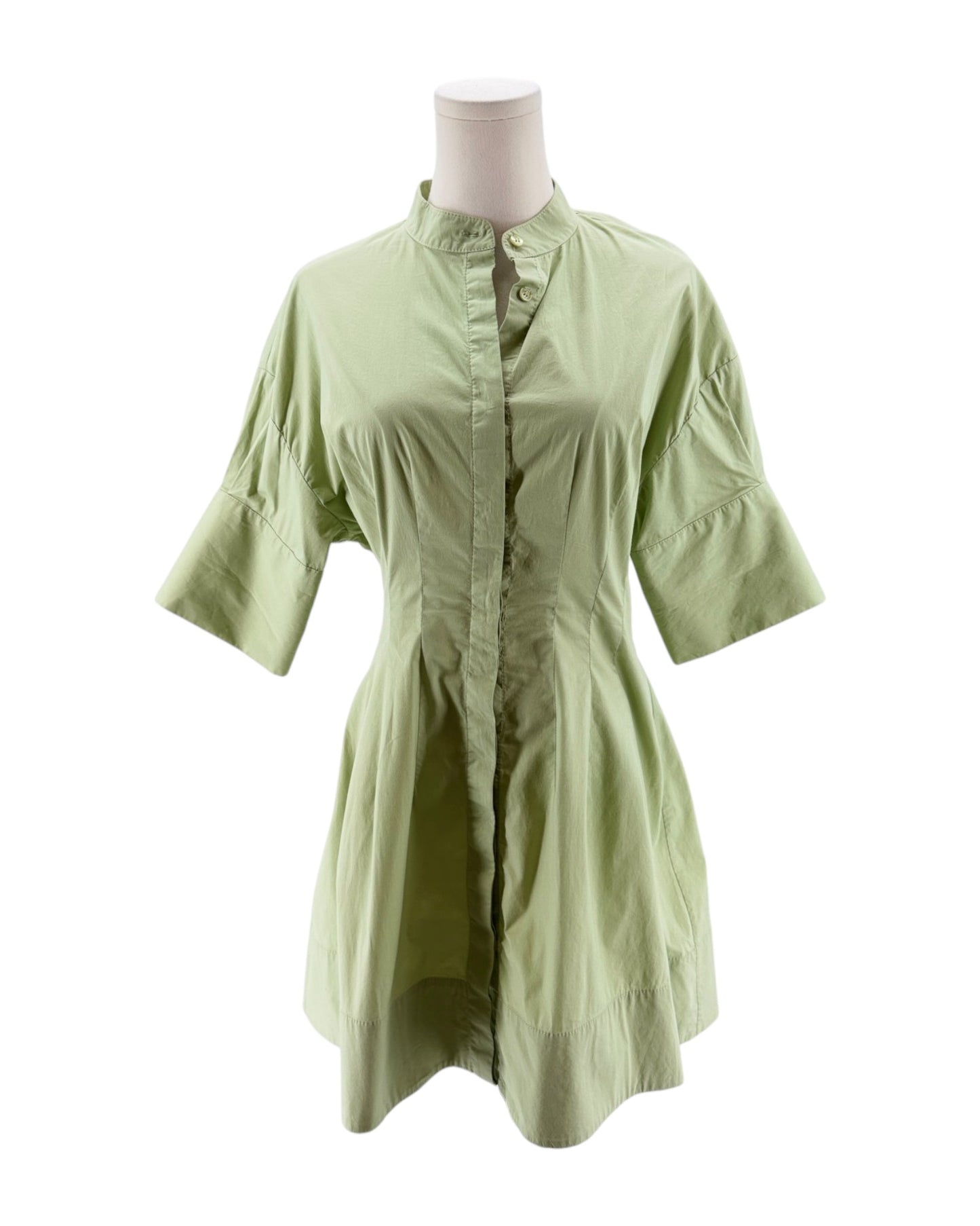 Light green dress on a mannequin against a white background