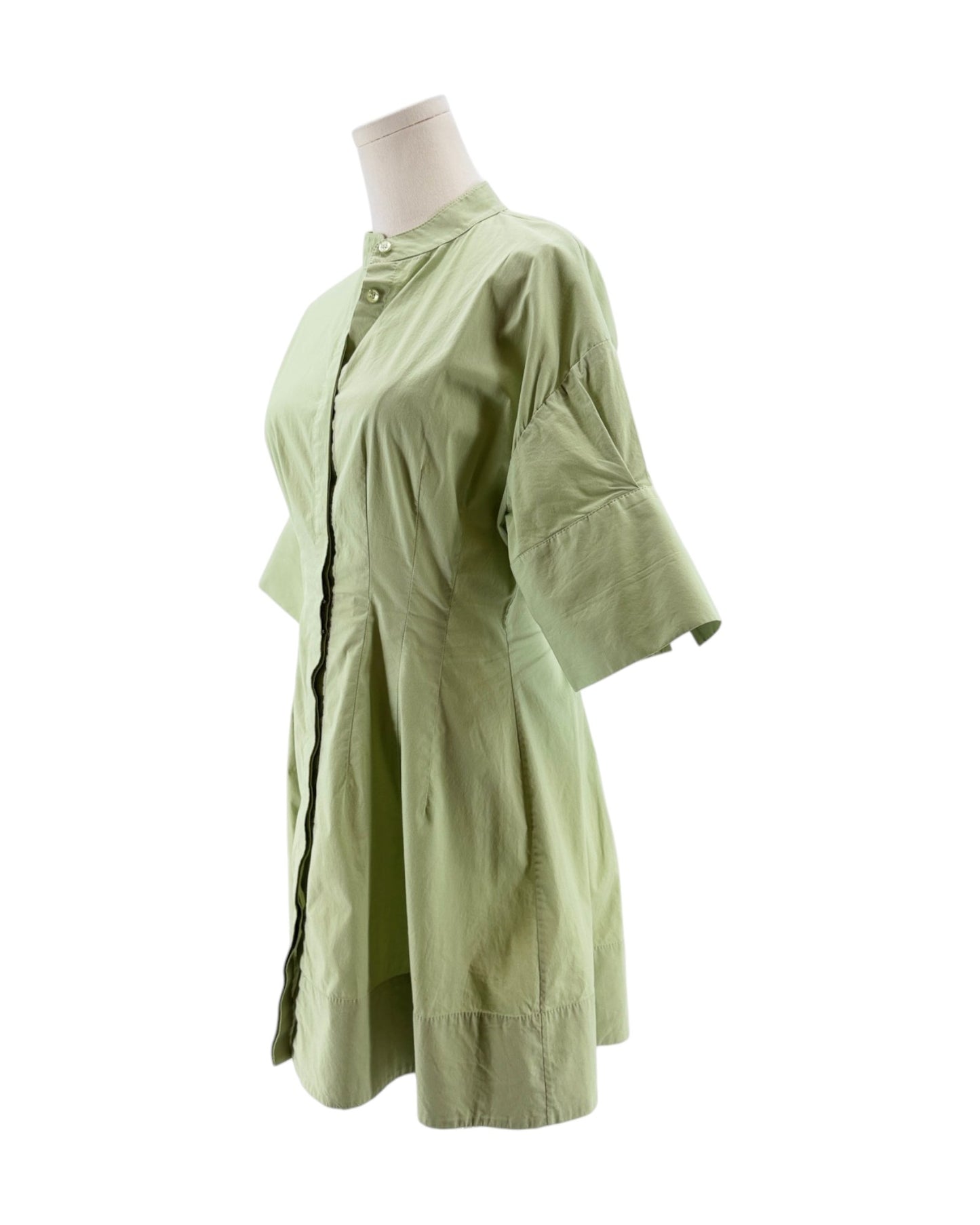 Light green dress on a mannequin against a white background