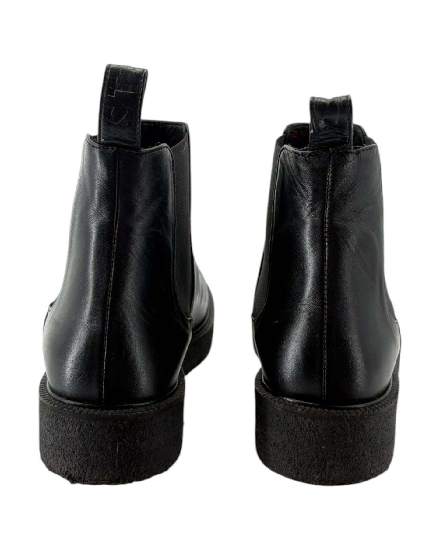 Black leather ankle boots on a white background