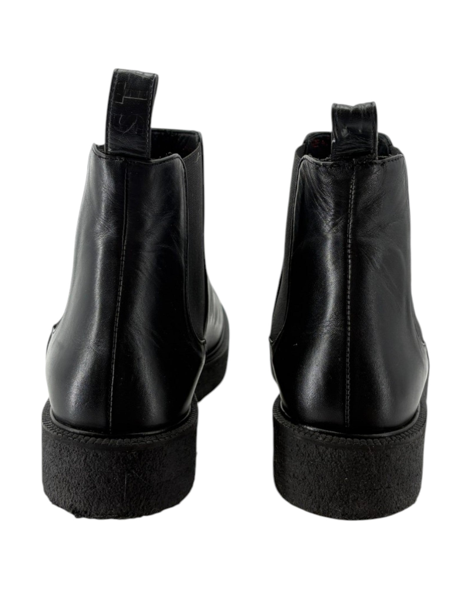 Black leather ankle boots on a white background