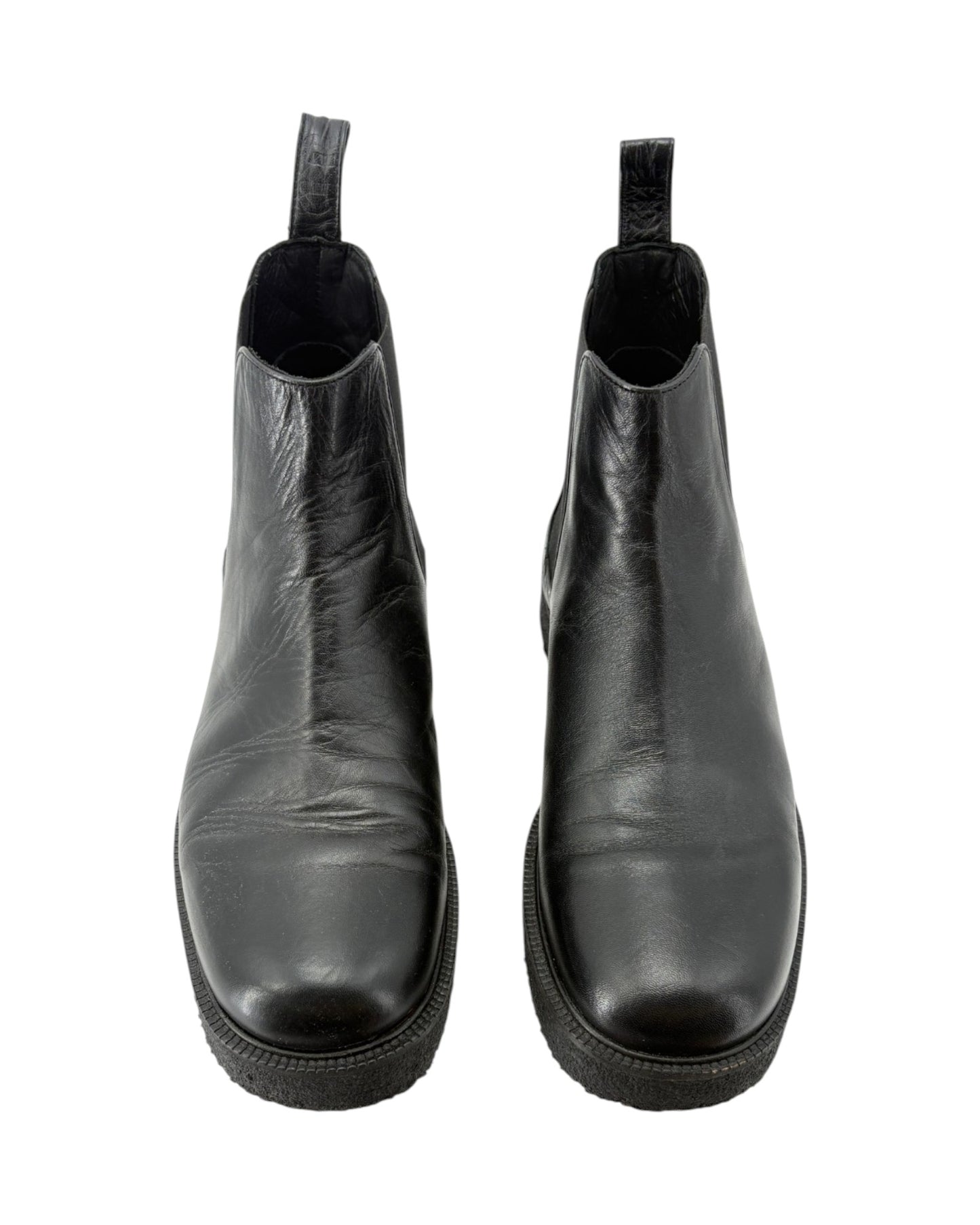 Pair of black leather ankle boots on a white background