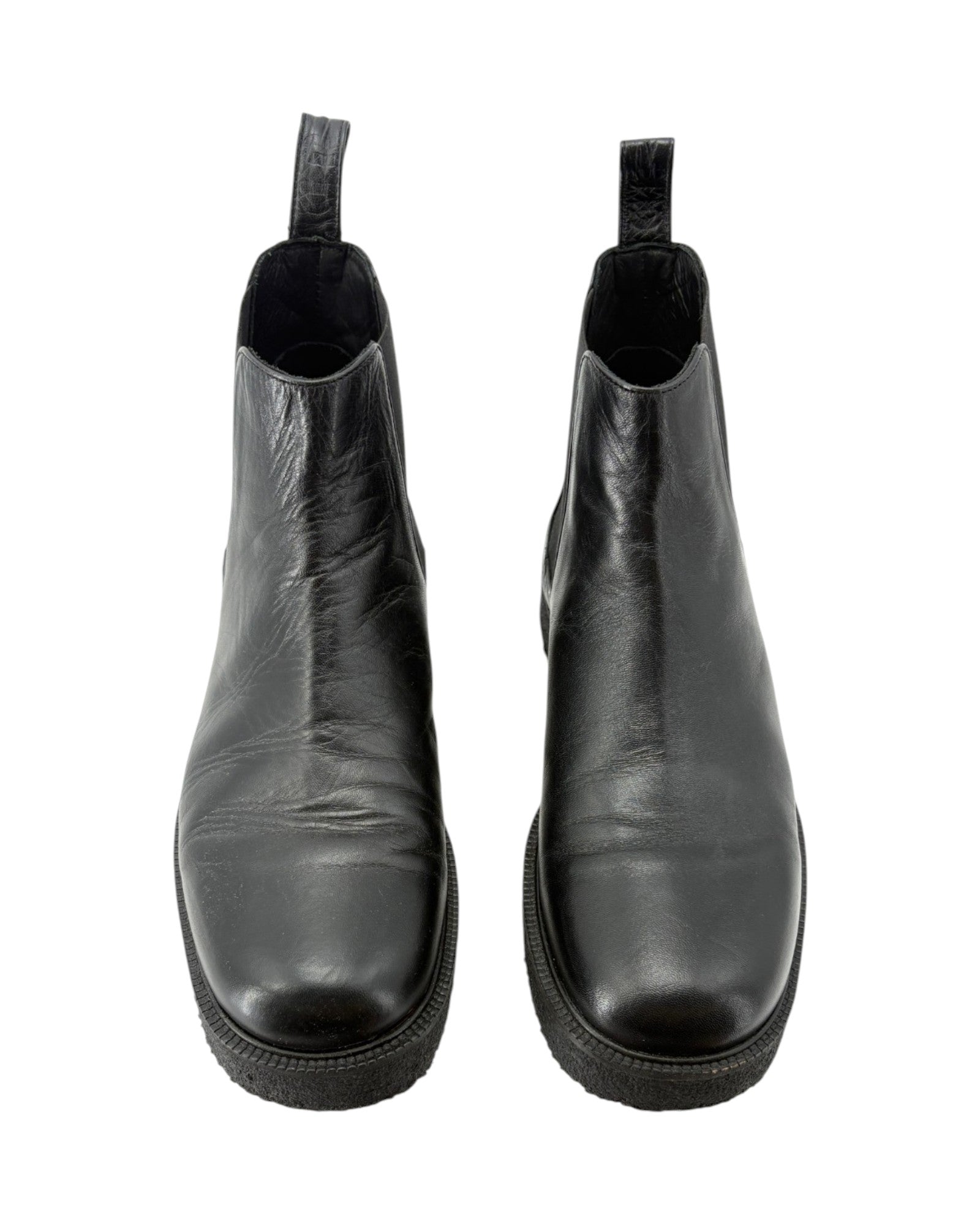 Pair of black leather ankle boots on a white background