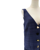 Navy blue dress with gold buttons on a mannequin against a white background