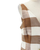 Plaid patterned fabric on a mannequin with a white background