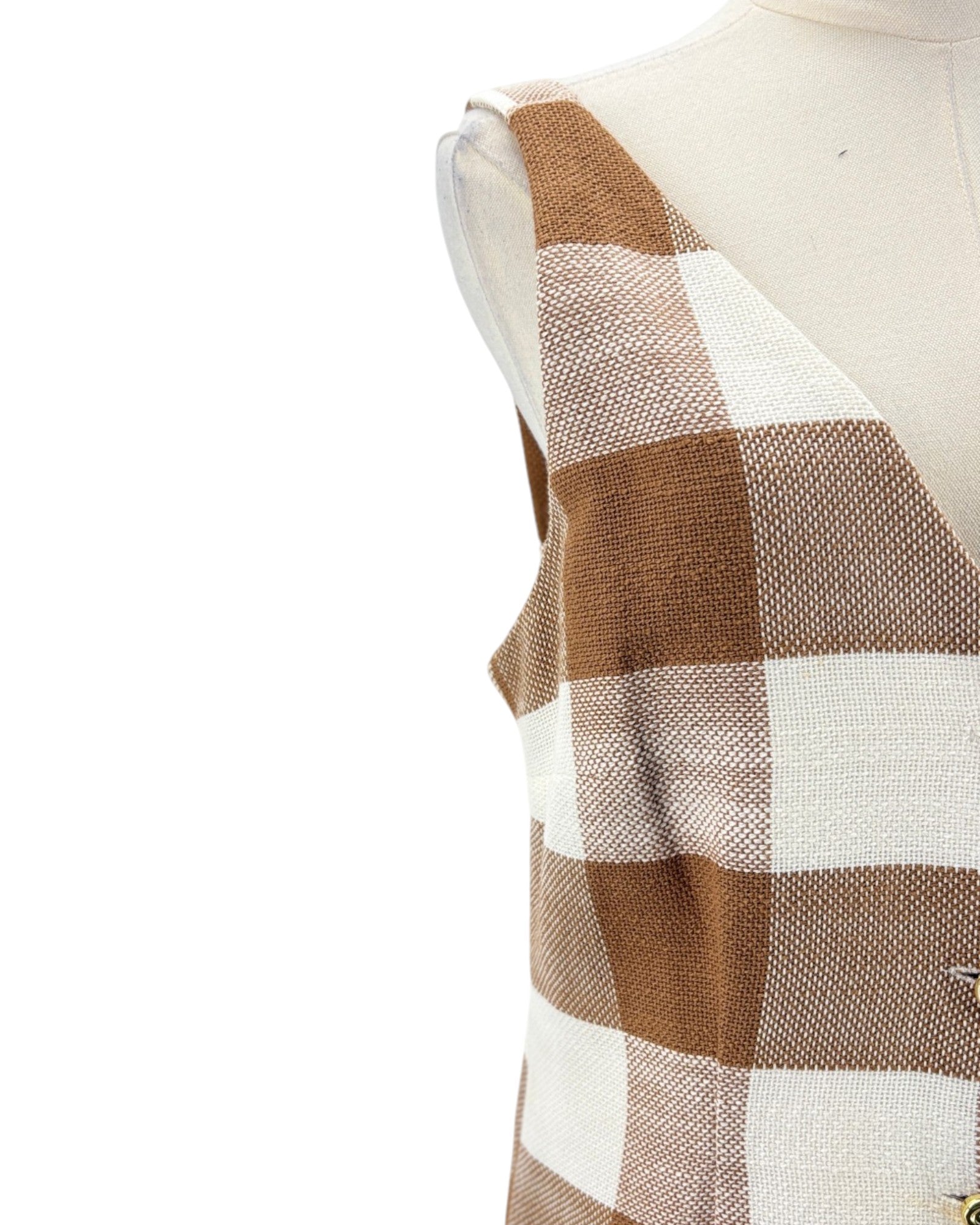 Plaid patterned fabric on a mannequin with a white background