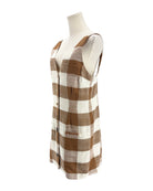Plaid patterned fabric on a mannequin with a white background
