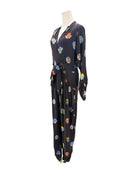 Black jumpsuit with colorful abstract patterns on a mannequin against a white background