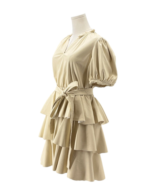 Beige dress on a mannequin against a white background