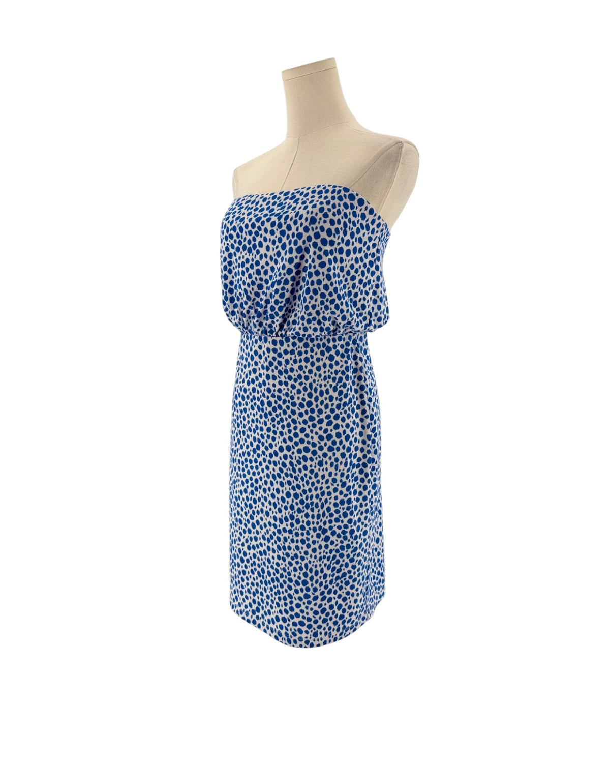 A strapless tube dress with a blue and white spotted pattern, displayed on a cream-colored mannequin torso against a plain white background.