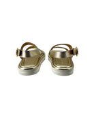 Pair of gold sandals on a white background