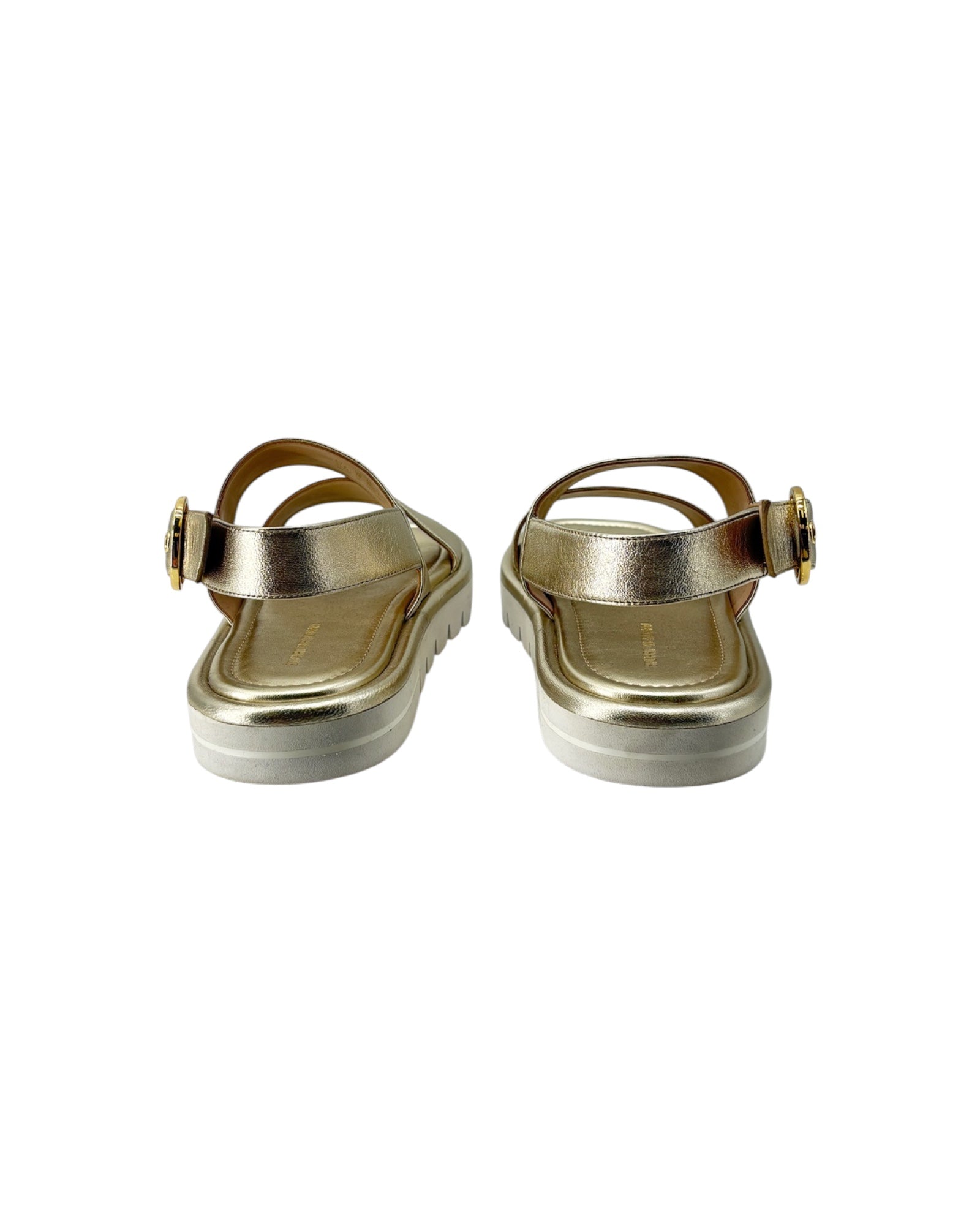 Pair of gold sandals on a white background