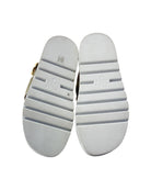 White shoe soles with visible branding on a white background