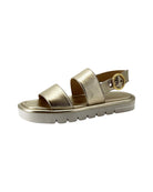 Gold sandal with a platform sole on a white background