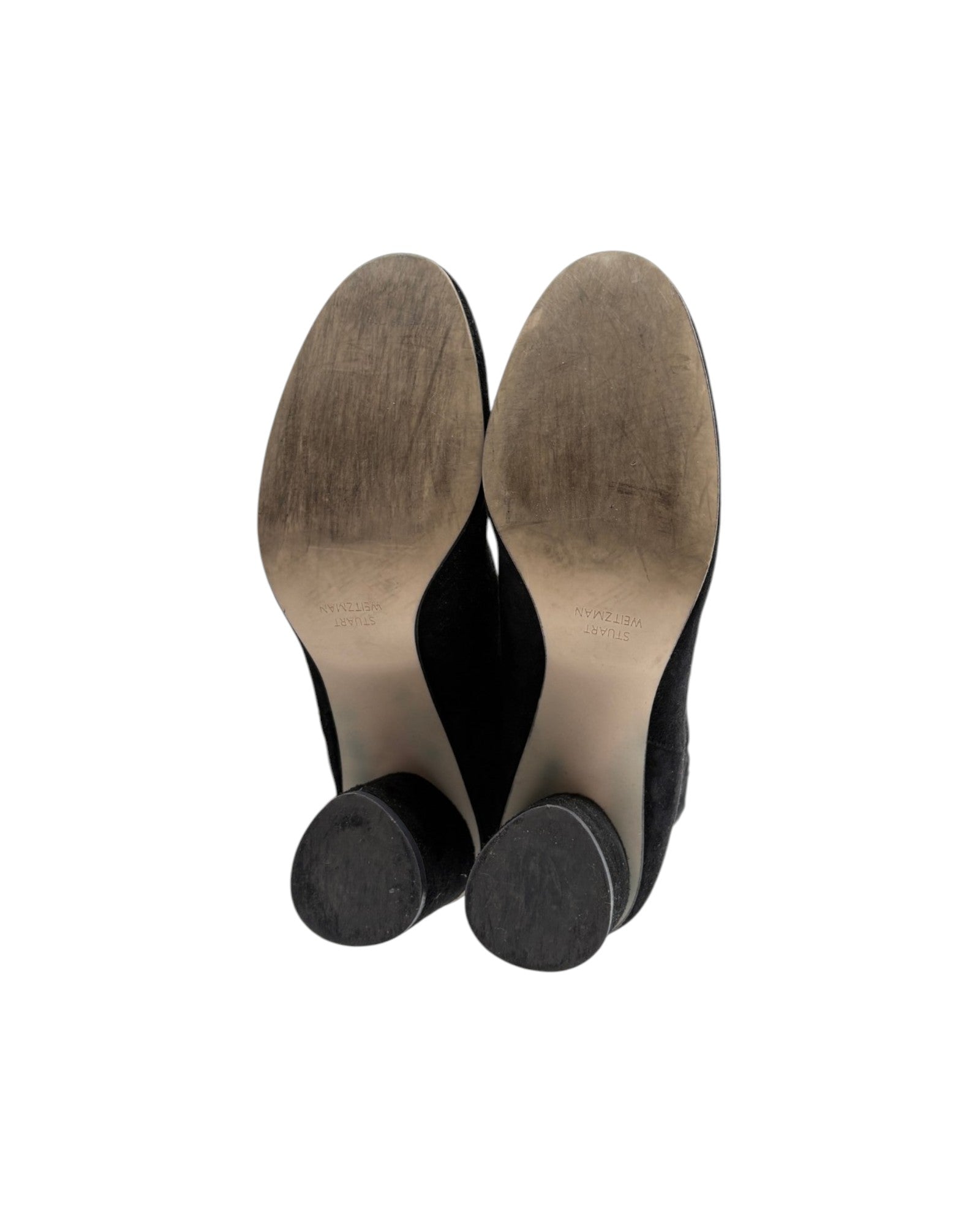 A pair of black ankle boots shown from a top-down view, displaying their tan insoles and black heels against a plain white background.