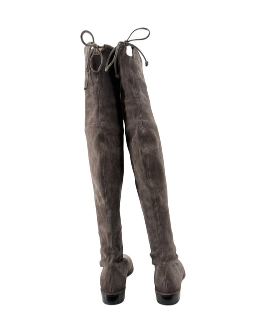 A pair of dark brown suede over-the-knee boots with lace-up front details, shown from the back against a plain white background.