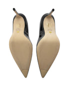 Pair of black and beige high-heeled shoes on a white background