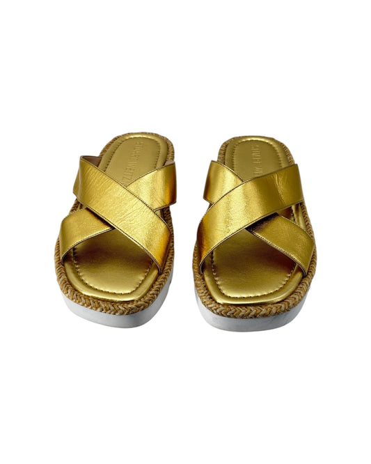 Pair of gold sandals with jute sole on a white background