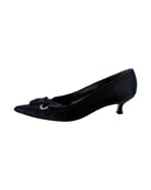 Pair of black high-heeled shoes with bow details on a white background