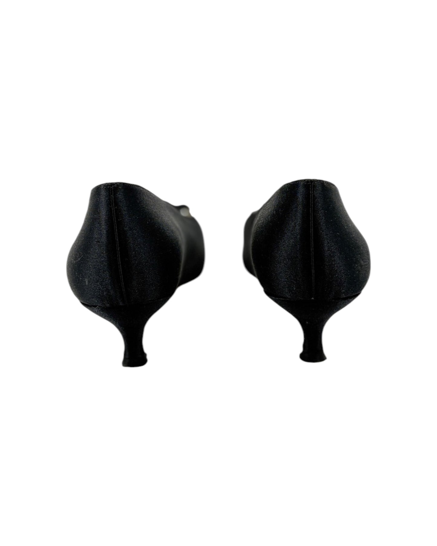Pair of black high-heeled shoes with bow details on a white background