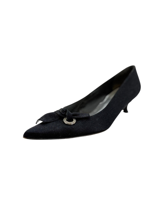 Black shoe with a decorative bow on a white background