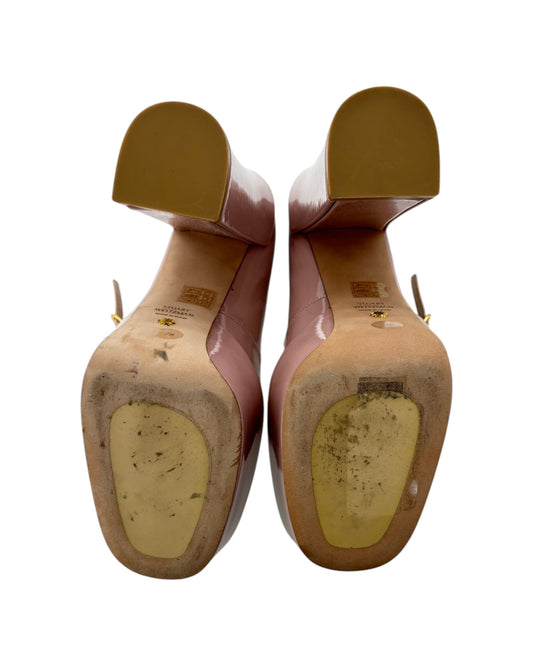 Pair of high-heeled shoes with visible wear on a white background