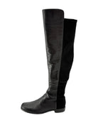Black knee-high boots on a white background