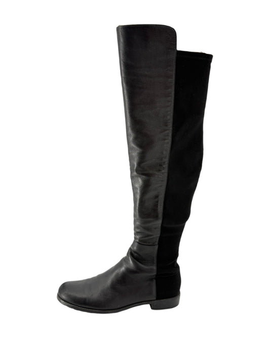 Black knee-high boots on a white background