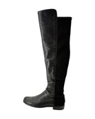 Black knee-high boots on a white background