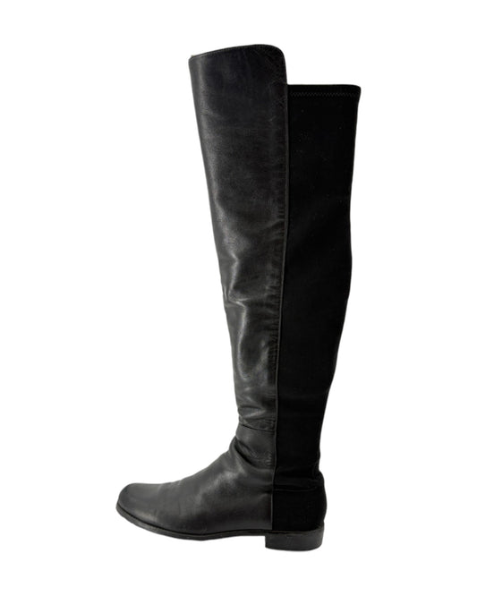 Black knee-high boots on a white background
