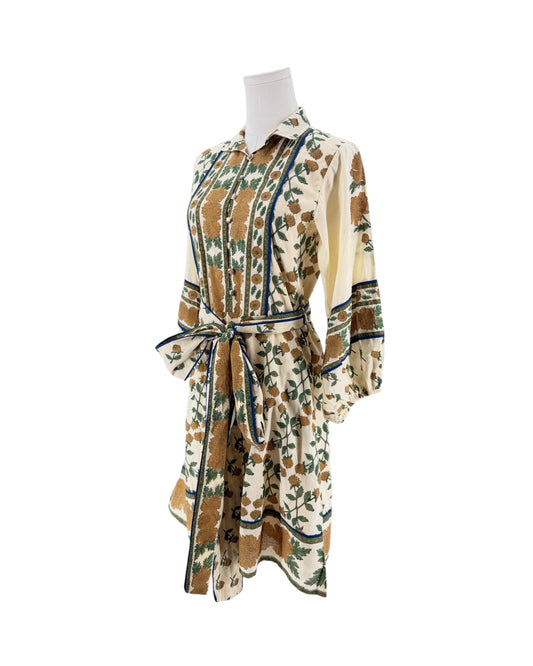 A long-sleeve collared dress with a matching waist tie, featuring a brown and green floral pattern on a cream background, displayed on a mannequin against a white background.