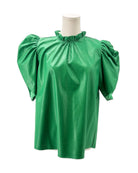Green vegan leather  blouse with puff sleeves on a mannequin against a white background