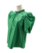 Green blouse with puff sleeves on a mannequin against a white background