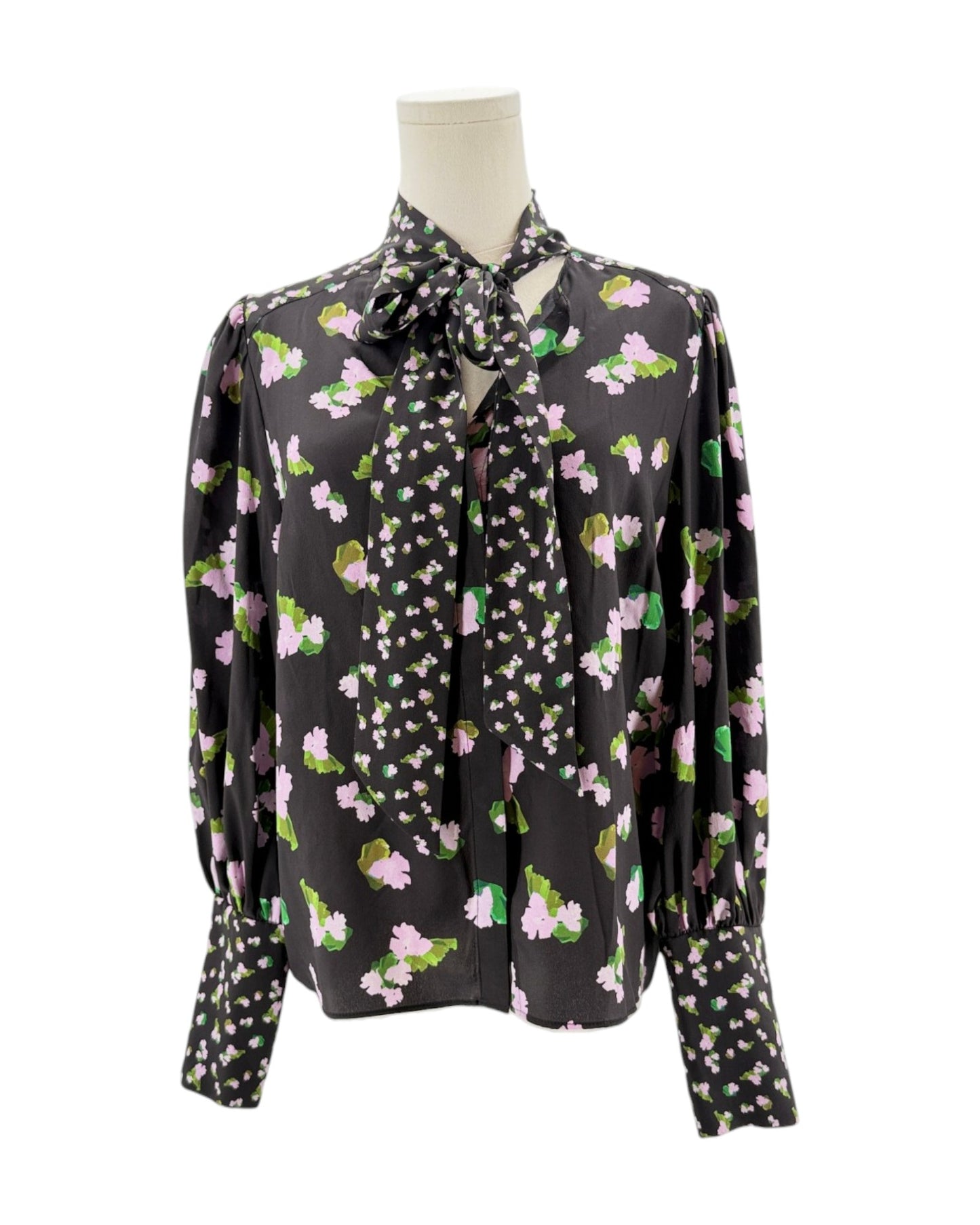 Floral patterned blouse on a mannequin against a white background