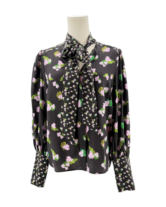 Floral patterned blouse on a mannequin against a white background