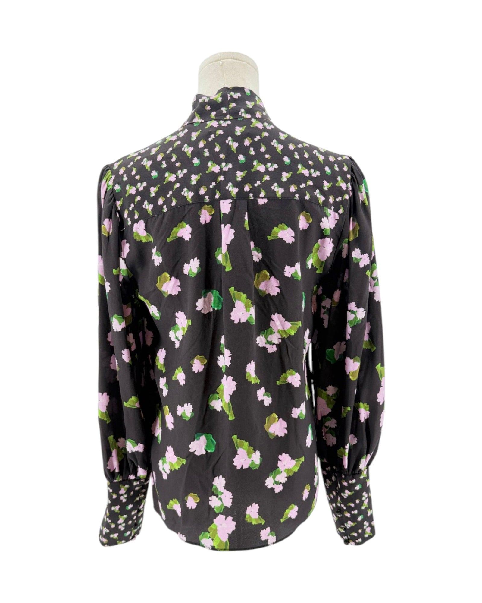Floral patterned blouse on a mannequin against a white background