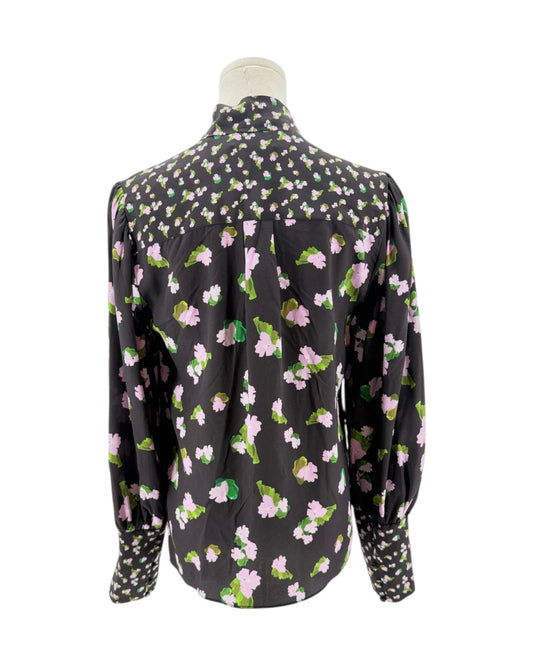 Floral patterned blouse on a mannequin against a white background