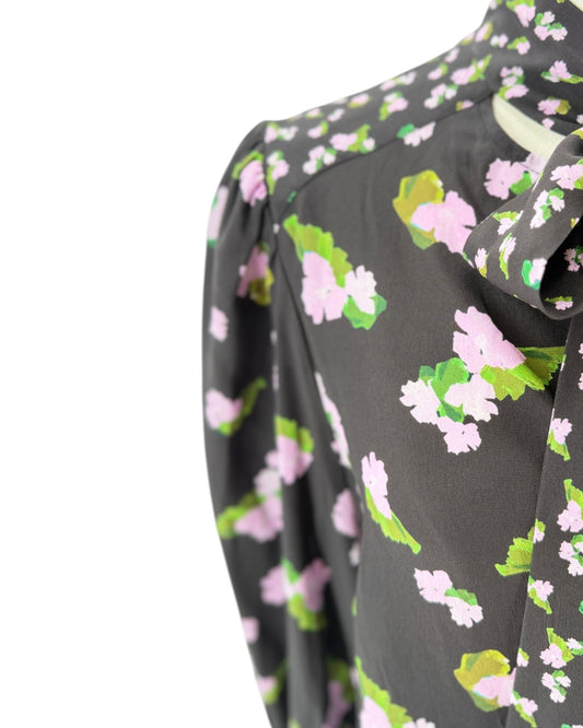 Floral patterned blouse with long sleeves on a white background