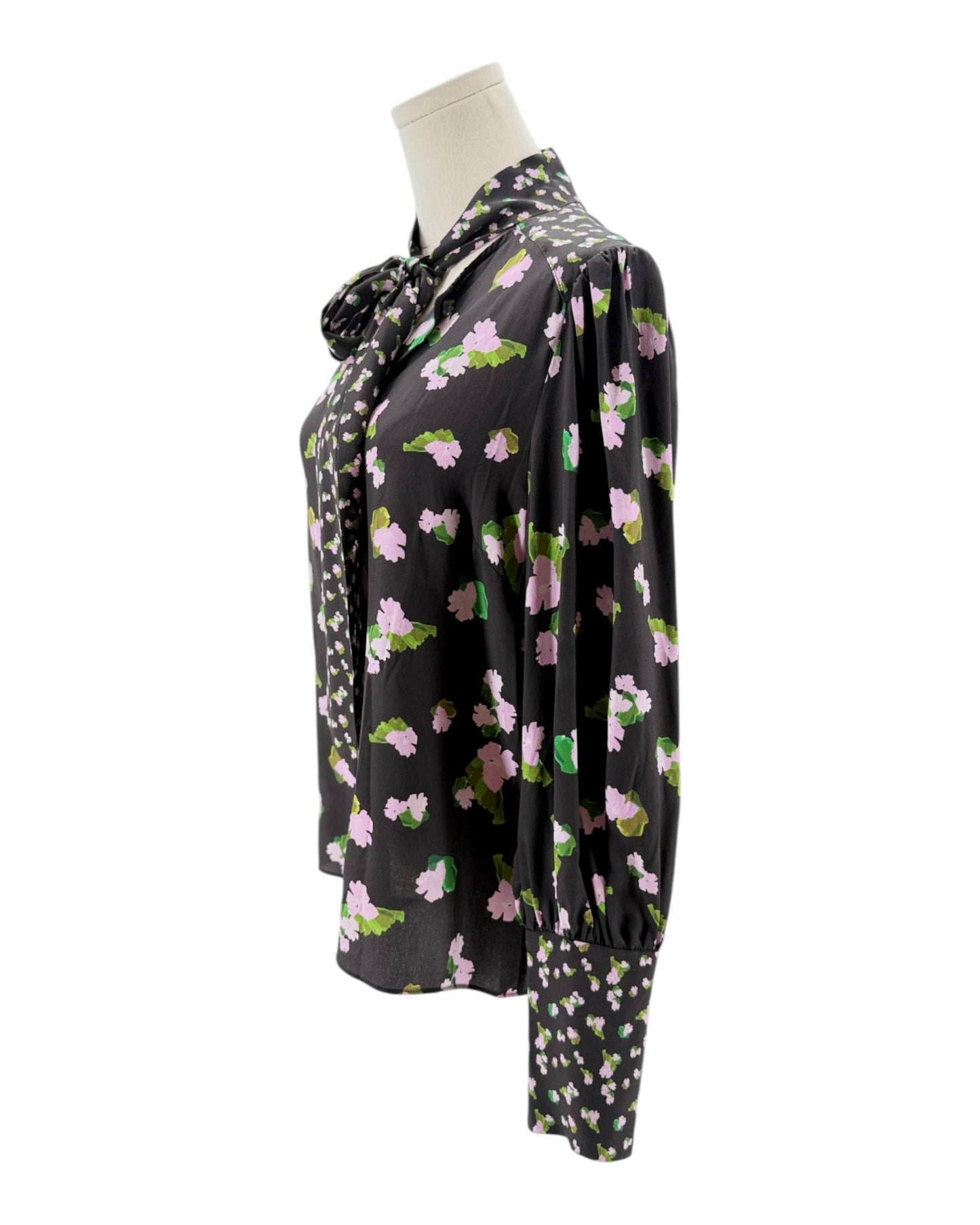 Floral patterned blouse on a mannequin against a white background