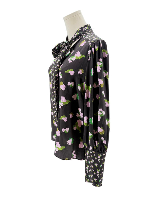 Floral patterned blouse on a mannequin against a white background