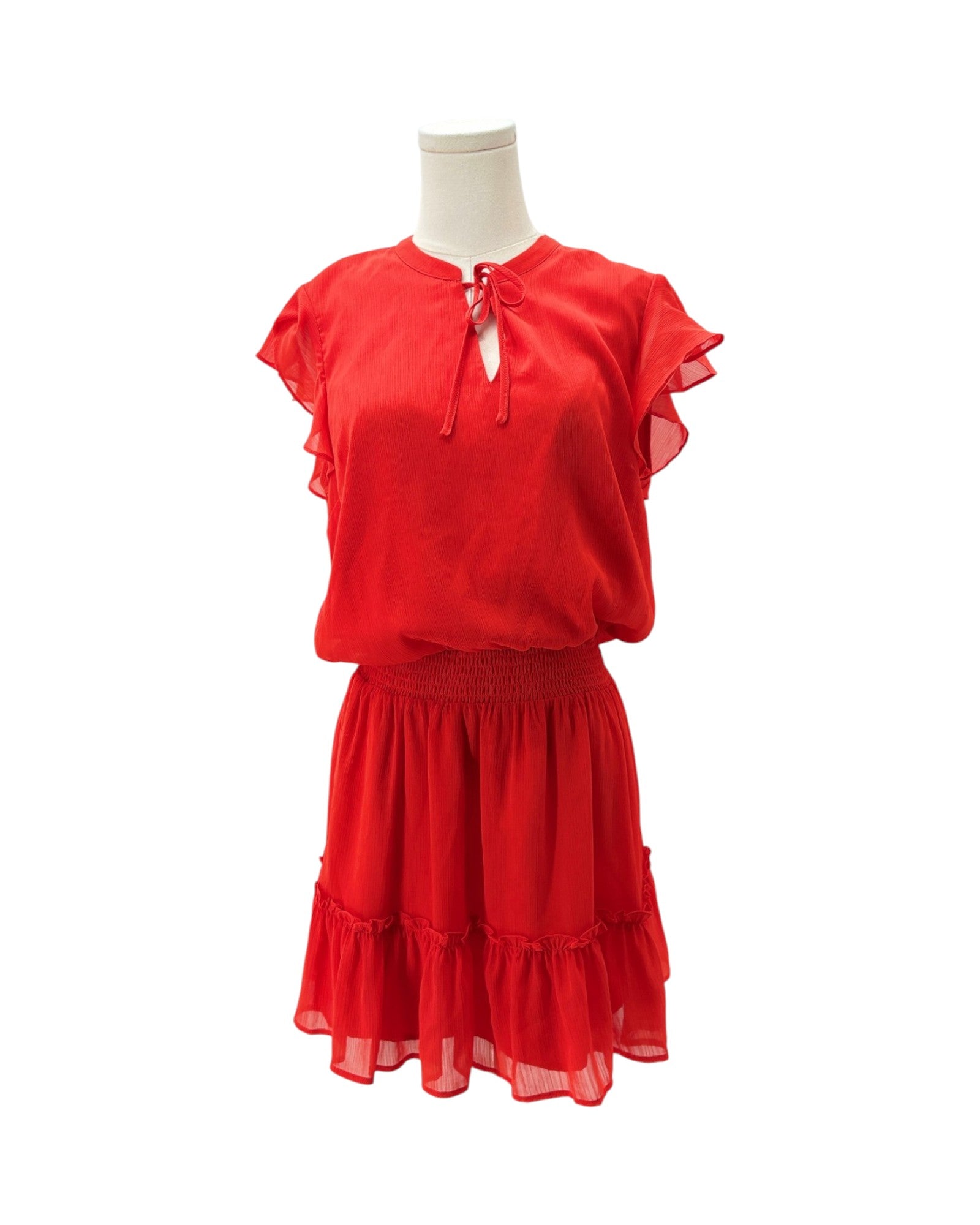 A bright red two-piece set consisting of a short-sleeve blouse with ruffled sleeves and a keyhole tie neckline, paired with a matching tiered ruffled skirt, displayed on a mannequin against a white background.